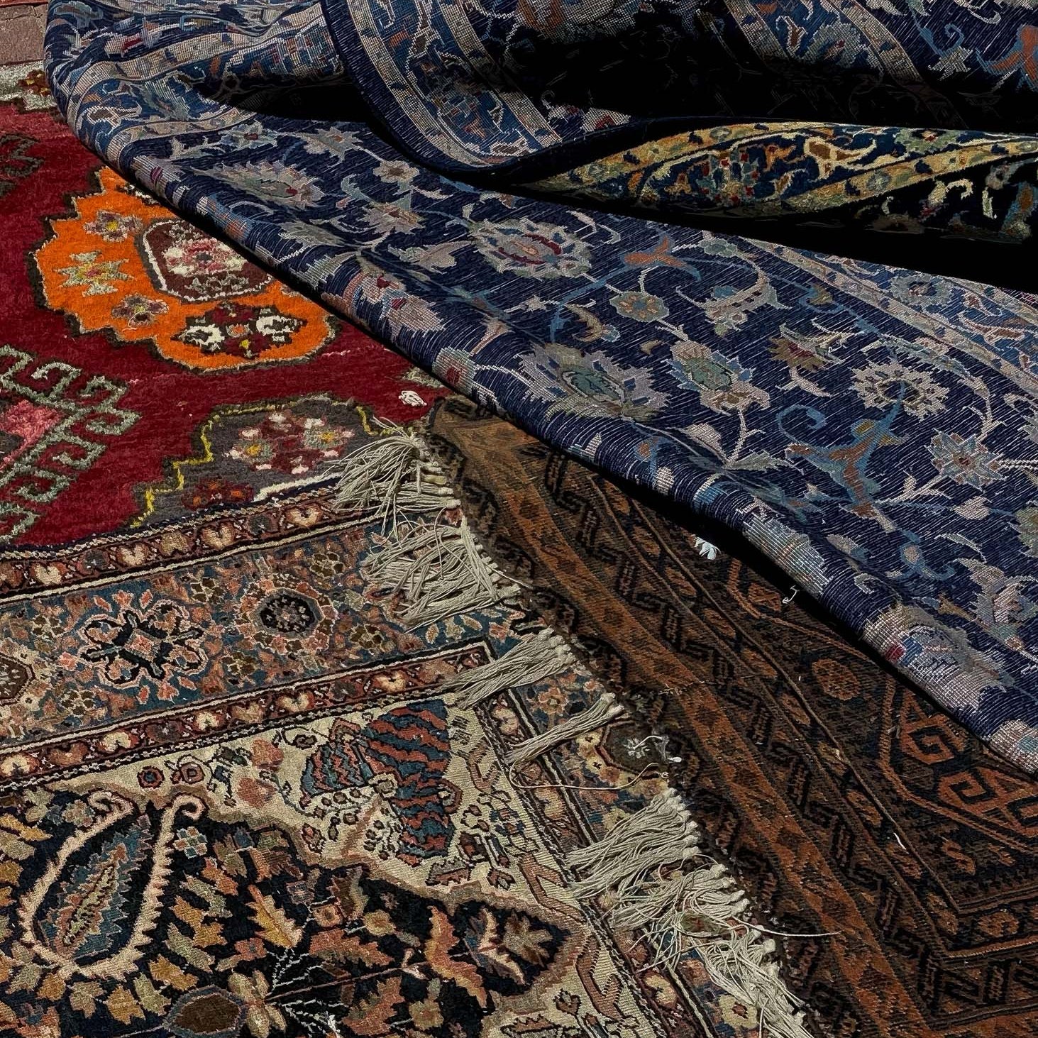 Printed Poster featuring vibrant Tel Aviv Carpets in a pile showcasing intricate designs and rich colors.