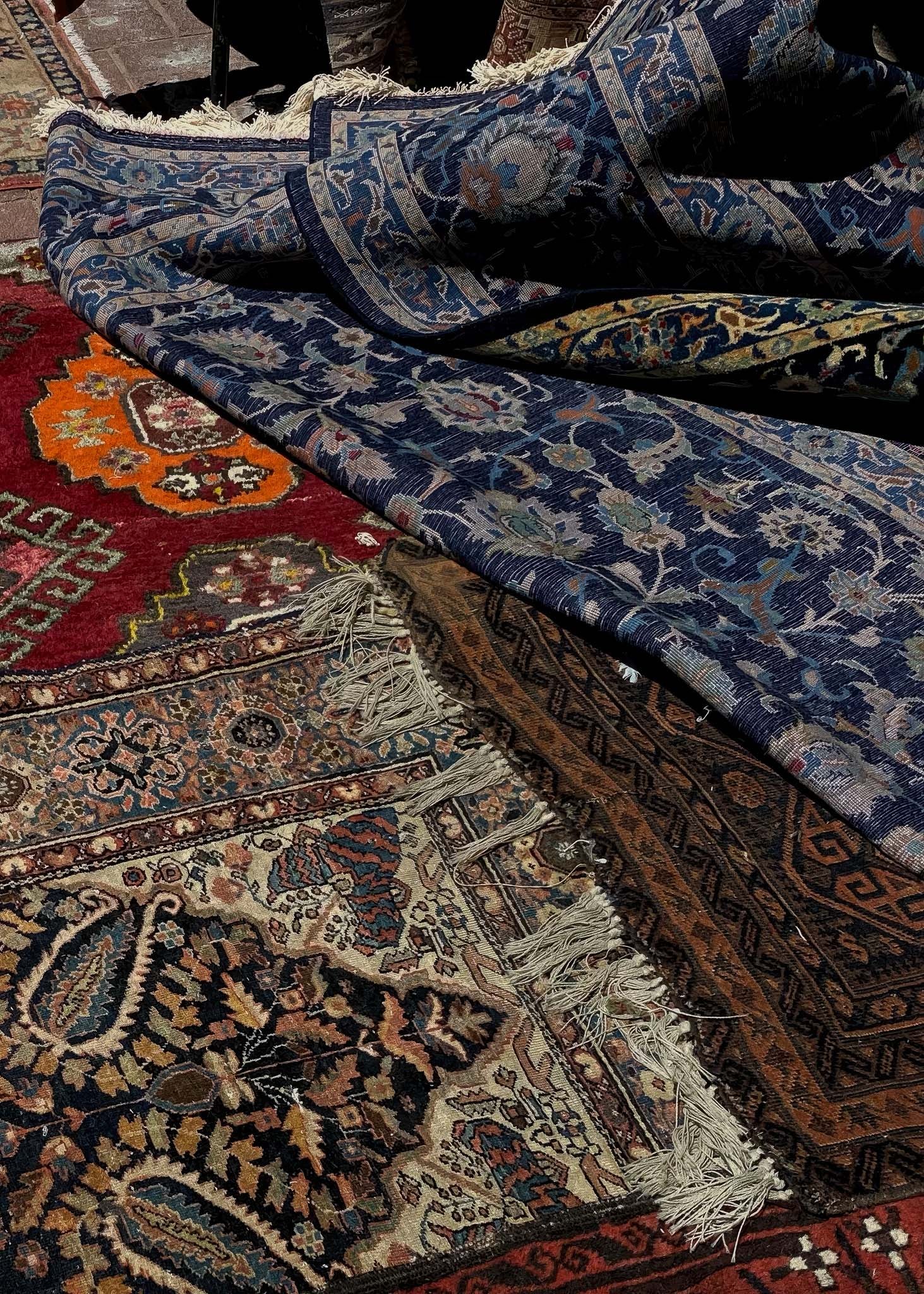 Printed Poster featuring vibrant Tel Aviv Carpets in a pile showcasing intricate designs and rich colors.