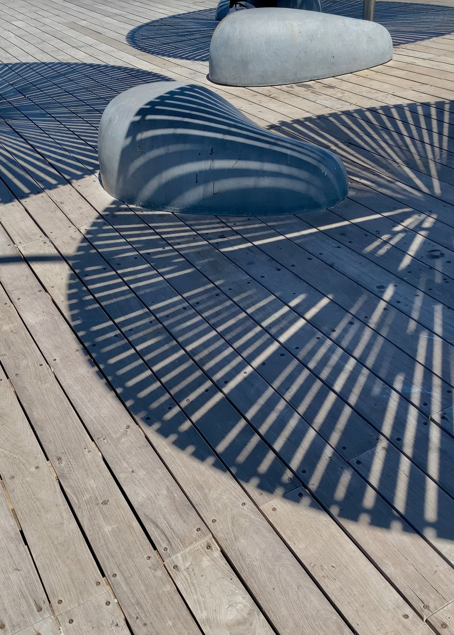 Printed Poster featuring shadows on wooden deck with curved shapes, perfect for decor.