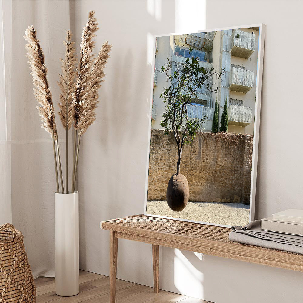 Suspended Orange Tree photography print displayed on a wooden table with decorative plants in a modern interior.