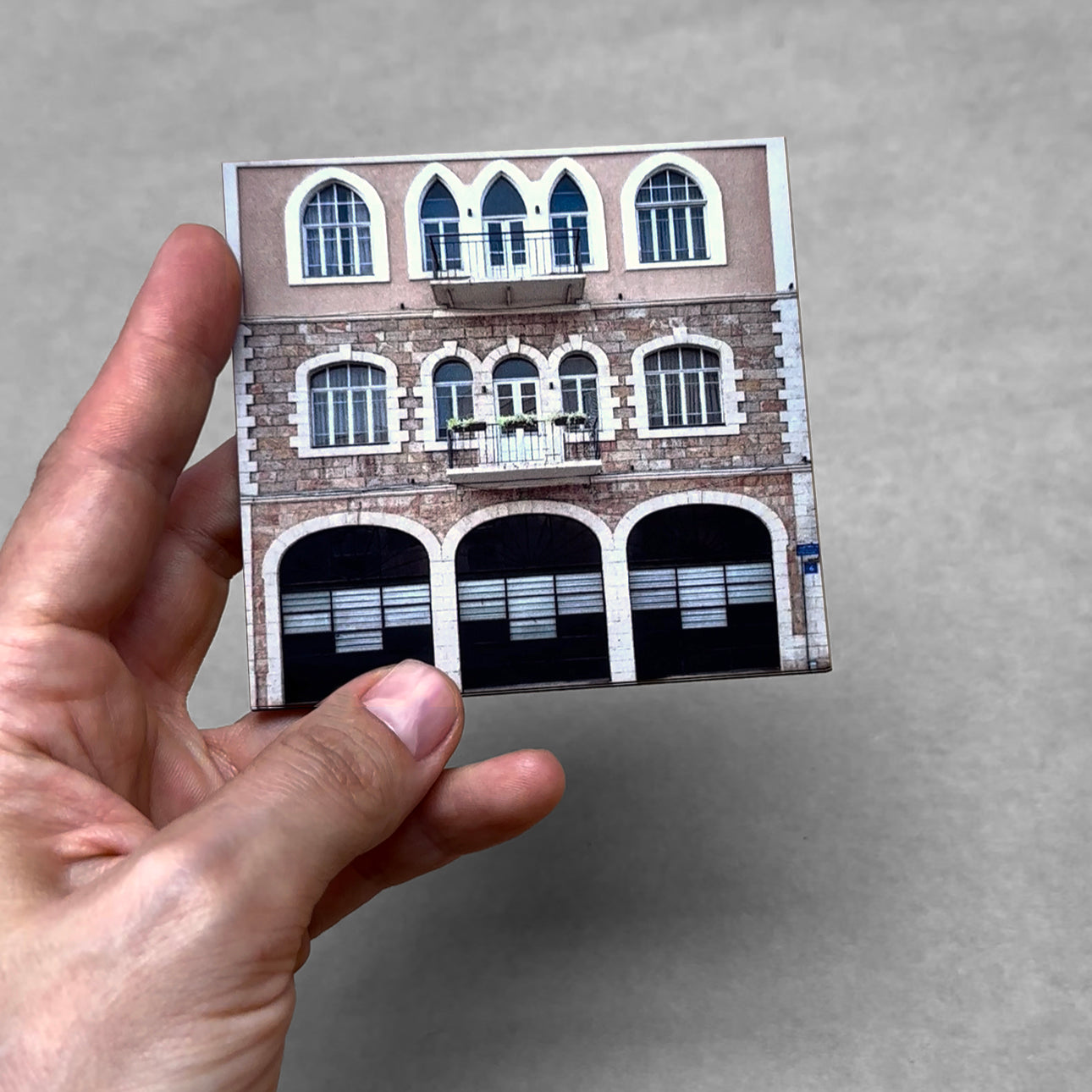 Hand holding a miniature of a historic building from THIS IS TEL AVIV Israel Souvenir — City Miniature.