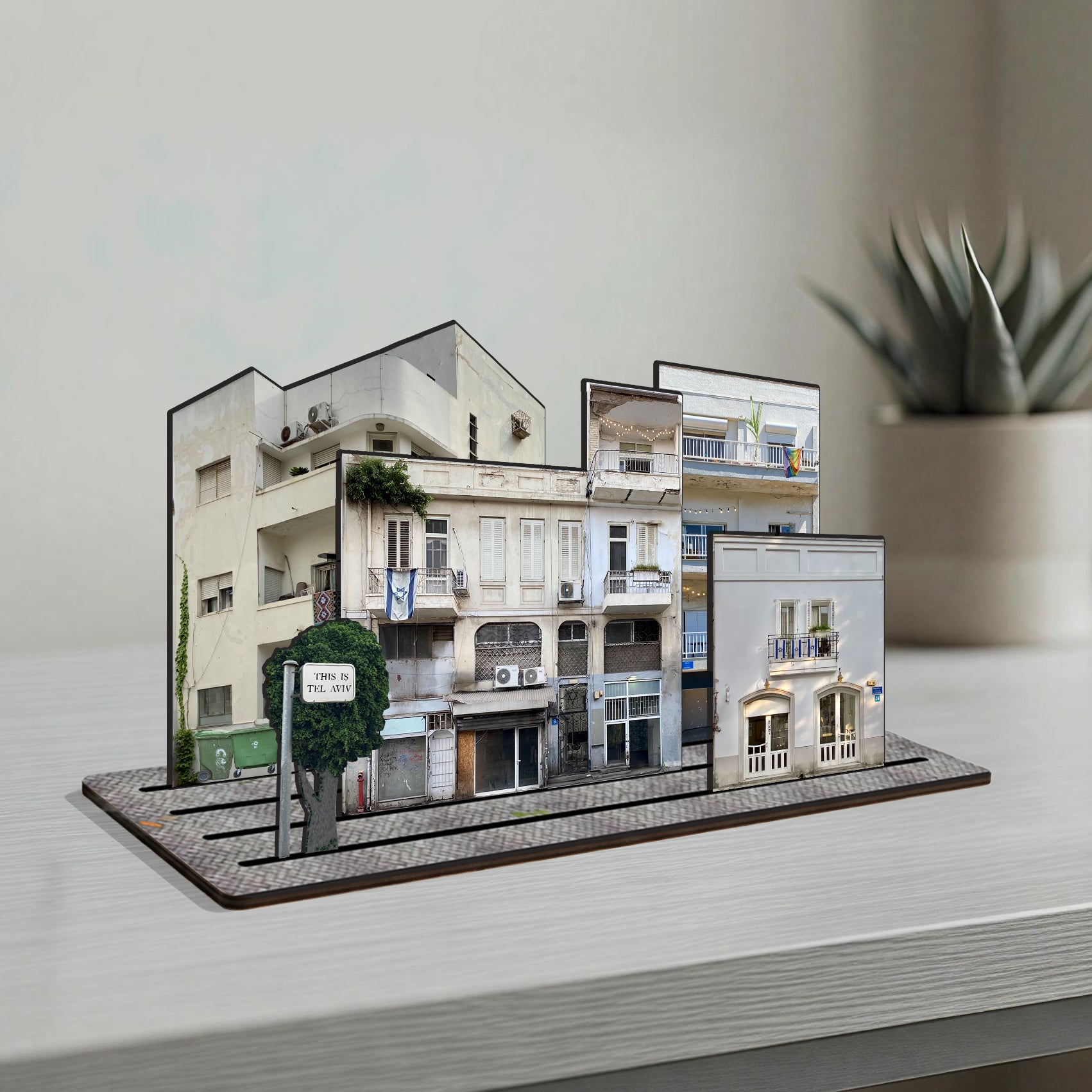 THIS IS TEL AVIV — Wooden Miniature showcasing white buildings and urban charm of Tel Aviv on a desk.